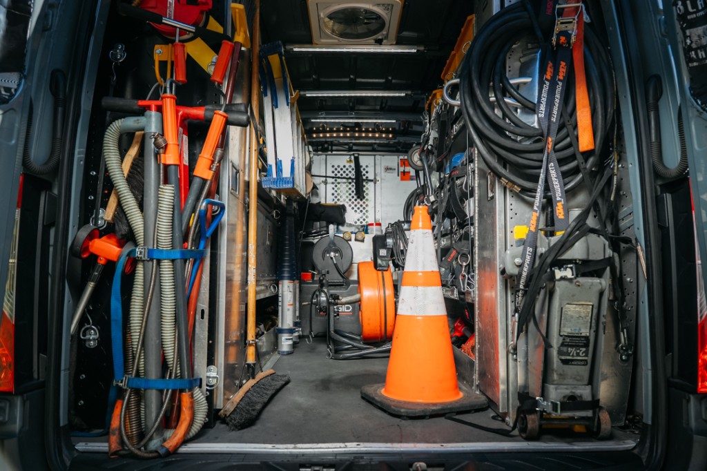 Fully stocked Pros Plumbing & Rooter service van with professional drain and plumbing equipment
